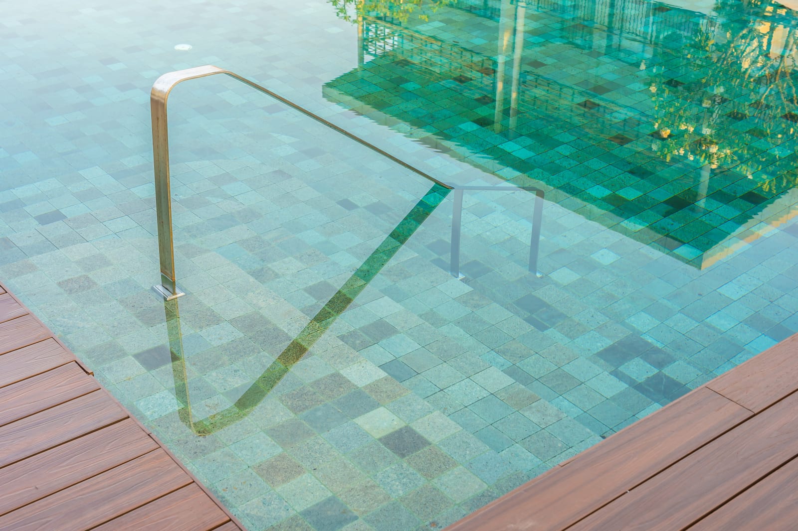 An outdoor residential pool with a stair ladder, the kind of setup our pump and filter work keeps running