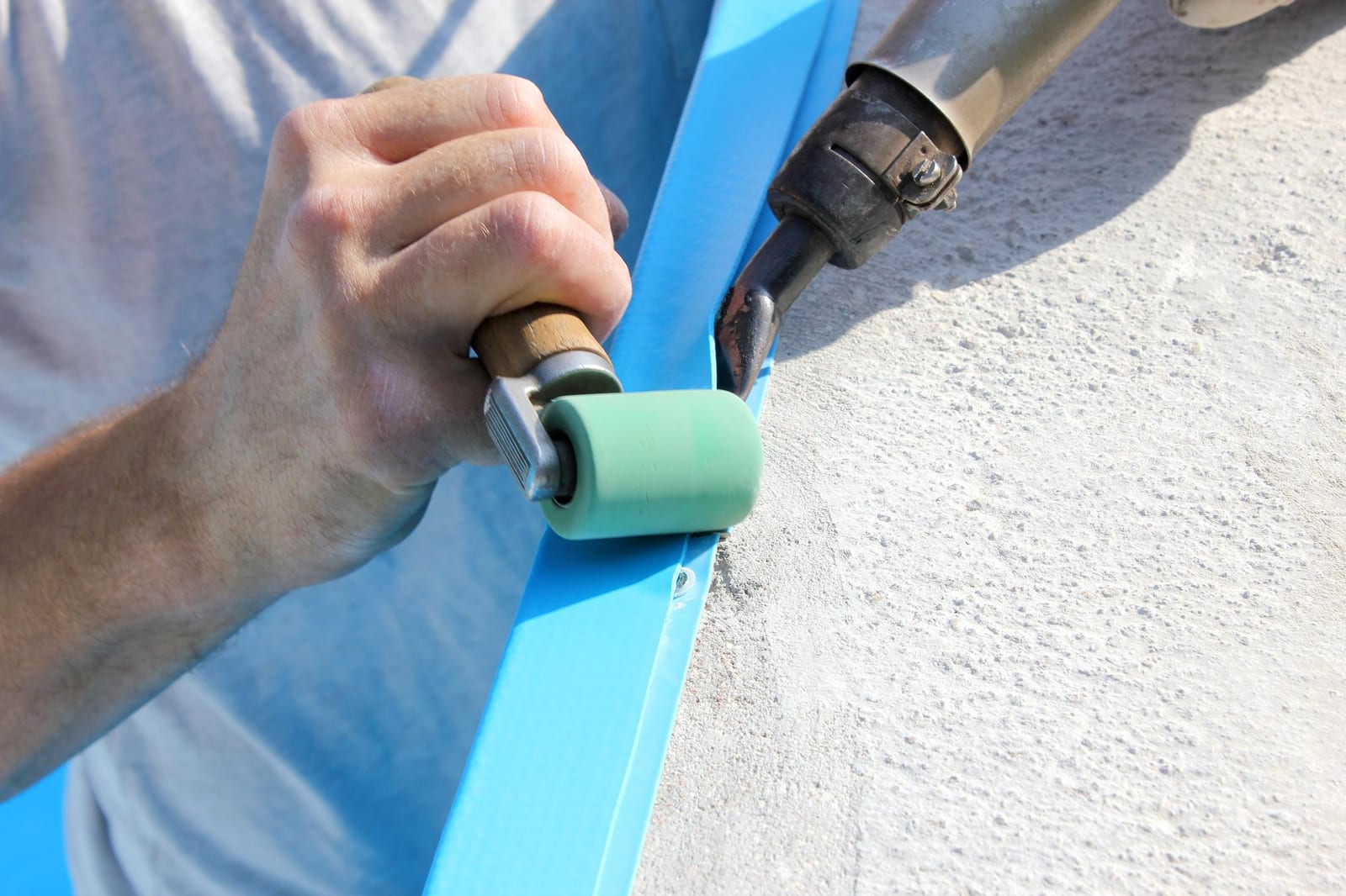 A technician welding a replacement liner seam during an equipment-adjacent repair visit