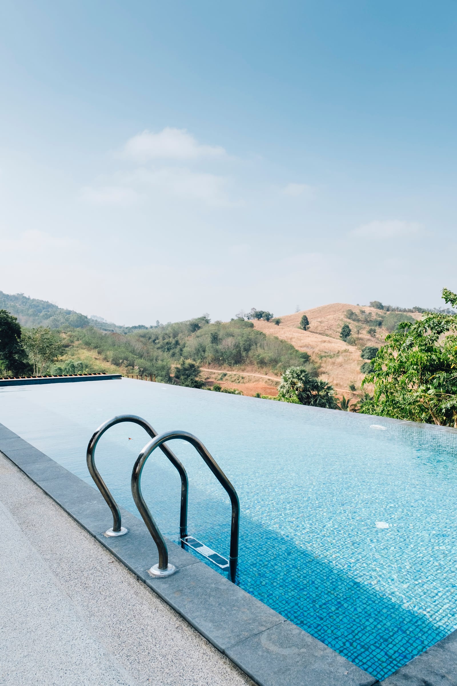 A pool with mountains in the background, reflecting the seasonal setting equipment must handle through the year